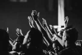 grayscale-photo-of-people-raising-their-hands-1666816-scaled-1.jpg